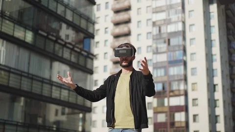 Man exploring virtual reality in street Stock Footage 113697147