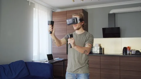 Man exploring vt with headset and controllers Stock Footage 128652463