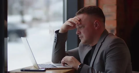 Man exploring work online sitting in cafe, focused. Browse information on laptop Stock Footage 170539329