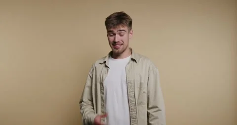 Man expresses different emotions in four frames while standing against a pl.. Stock Footage 331989872