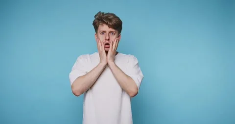 Man expresses different emotions in front of a blue wall in four frames dur.. Stock-Footage 331990903