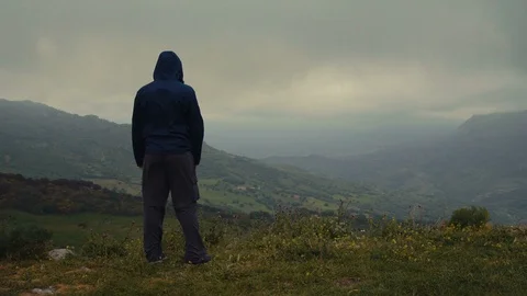 A man expressing freedom on top of a small mountain Stock Footage 88720290