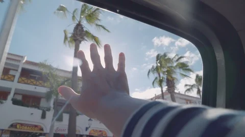 A man extends his hand to the sun through the window of a car Video stock 94927194