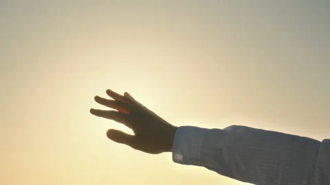 A man extends his hand toward the sun Stock-Footage 149678583