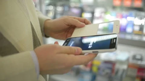 Man extracts of a Smartphone mobile cell phone from the white cover Stock Footage 58697373