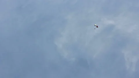 Man extremely descends with a parachute to the ground. Parachute flight Video stock 90312834