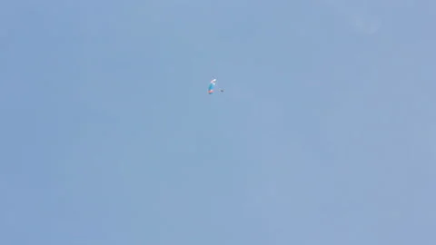 Man extremely descends with a parachute to the ground. Parachute flight Video stock 90361873