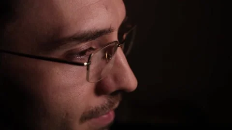 Man in eyeglasses late at night Coder, programmer or developer using laptop Stock Footage 146449190