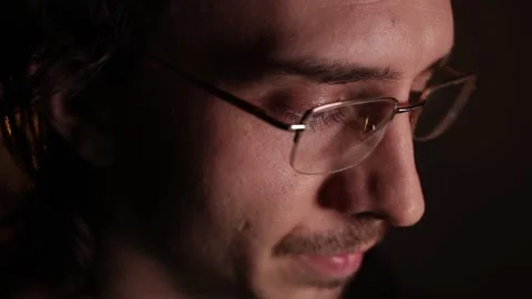 Man in eyeglasses late at night Coder, programmer or developer using laptop in Stock Footage 146450163