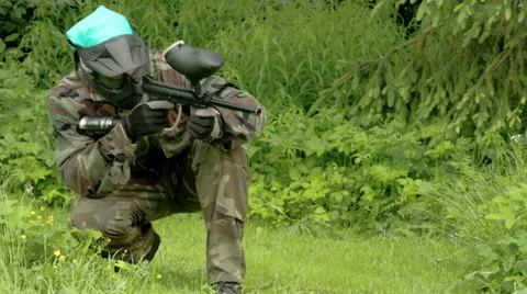 A man eyeing for an enemy with a paintball fs700 odyssey 7q Stock Footage 39726841