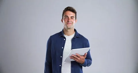 Man, face and smile with tablet in studio for social network, ebook subscription Stock Footage 257600391