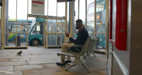 Man With Face Covering Using Phone in Bu... | Stock Video | Pond5