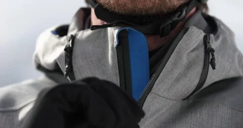 Man face detail closing jacket zip preparing for skiing.Mountaineering ski Stock Footage 84289235