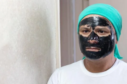 Man with face mask in front of mirror Stock Photos