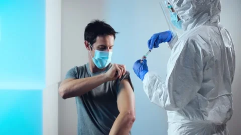 Man with face mask getting vaccinated, coronavirus concept. Stock Footage 146583441