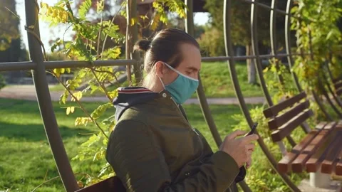 Man with face mask looking at phone. Stock Footage 144893543