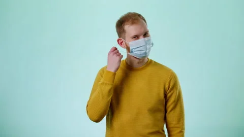 Man In Face Mask Takes Off Protective Mask, Smiling And Take A Deep Breath Stock Footage 170191331