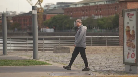 Man with a face mask walking during quarantine in Buenos Aires Stock Footage 128771074