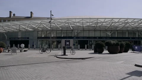 Man with face mask walking outside King's Cross underground station in London Stock Footage 130315015