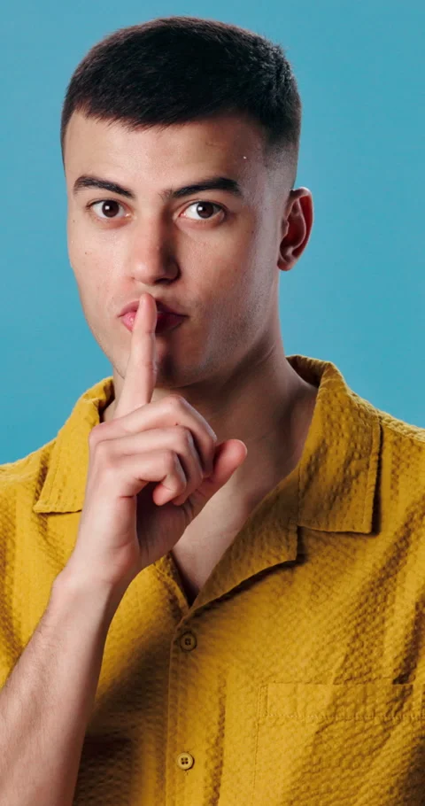 Man, face or lips with secret in studio for silence, quiet or confidential on a Stock Footage 343166369