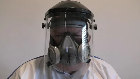 A man with face shield and mask protected from Coronavirus salutes with elbow Видео 141223959