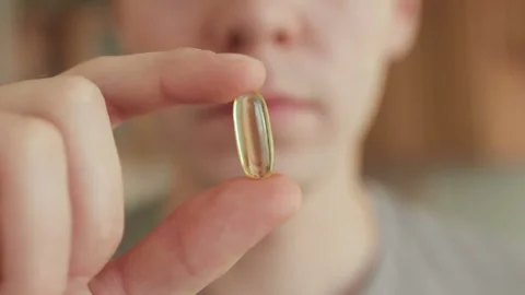 Man face taking omega 3 capsule and drinking water Stock Footage 101739178