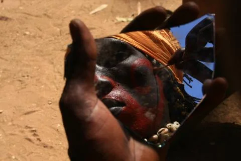 Man face using war colors and mirror Stock Photos