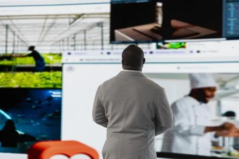 Man facing digital video wall, benefiting from endless entertainment selection Stock Photos