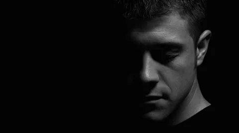 Man facing down with eyes closed in black and white Stock Footage 22956307