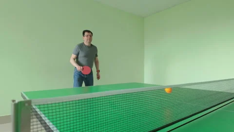 Man fails to return serve as ping pong ball hits net during table tennis Stock Footage 311641906