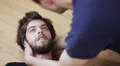 a man faints and is helped by a friend HD Footage