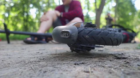Man fall when riding an electric scooter. Riding an e-scooter without protective Stock Footage 247360260