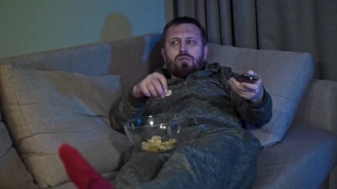 Man Falling Asleep on Sofa While Watching Television Late at Night Stock Footage 342353166