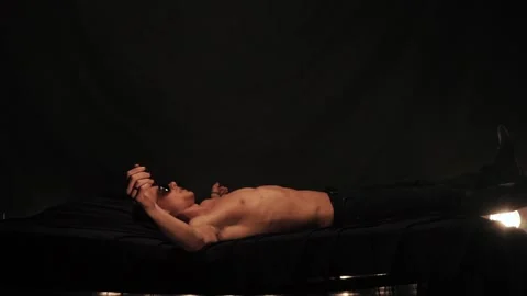 Man falling on bed on black background Stock Footage 88744958