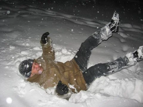 The man falling on a snow Stock Photos