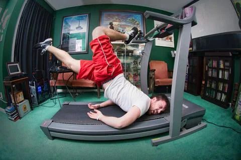 Man Falling on Treadmill During Home Workout Session Stock Photos