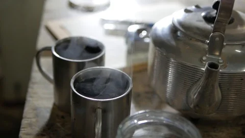 A man falls asleep sugar in a stainless cup with tea Stock Footage 99593513