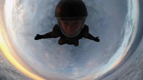 A man falls into a cloud, falling into the clouds from an airplane at sunset Video stock 178582278