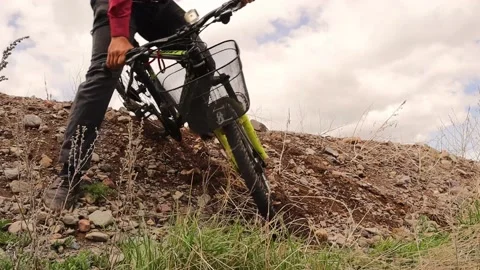 Man falls off his bike while descending a hill in the mountain. Small accident Stock Footage 155208663