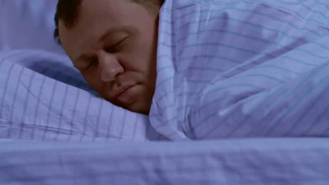 A man falls into his comfortable bed and quickly falls asleep Stock Footage 131249580
