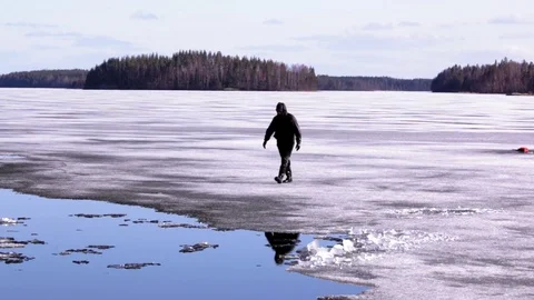 Man falls through weak ice and climbs back up Stock Footage 75393815
