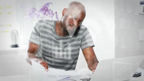 Man fanning documents then leaning toward laptop after finding error, updating Stock Footage 330258783