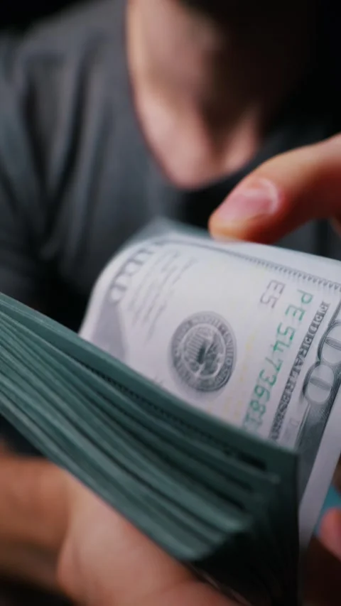 Man Fanning Through Stack of One Hundred Dollar Bills in Close Up View Stock Footage 339366754