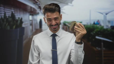 Man fans a thick stack of uae dirham banknotes while smiling under daylight.. Stock Footage 312356460