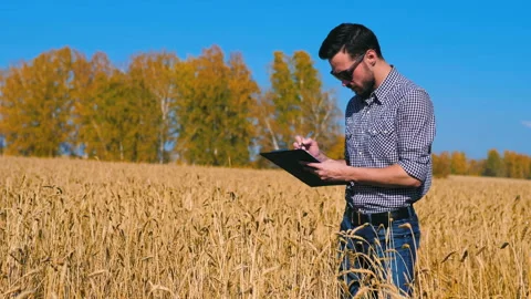 A man is a farmer working in the field. Stock Footage 97326074