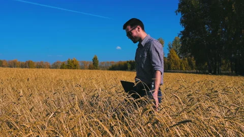 A man is a farmer working in the field. Stock Footage 97326750