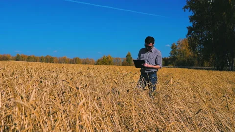 A man is a farmer working in the field. Stock Footage 97326907