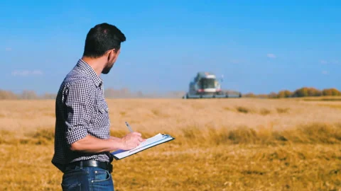 A man is a farmer working in the field. Stock Footage 97327265