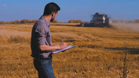 A man is a farmer working in the field. Stock Footage 97327367
