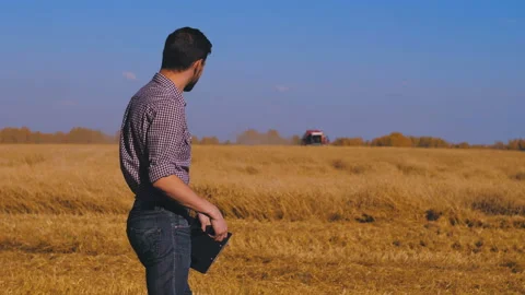 A man is a farmer working in the field. Stock Footage 97327614